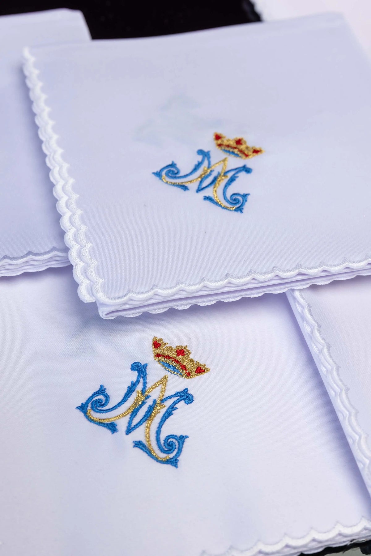 White corporal set with crowned Marian monogram, stacked close-up view