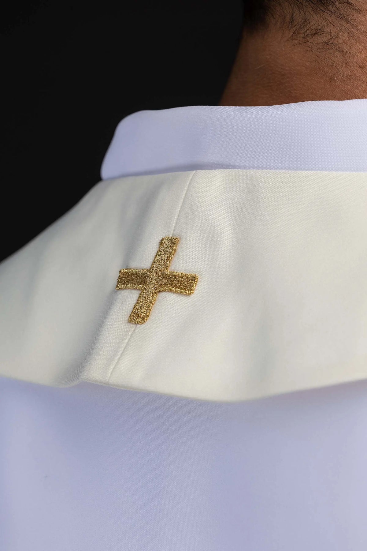 Ecru stole with embroidered gold cross, neck close-up