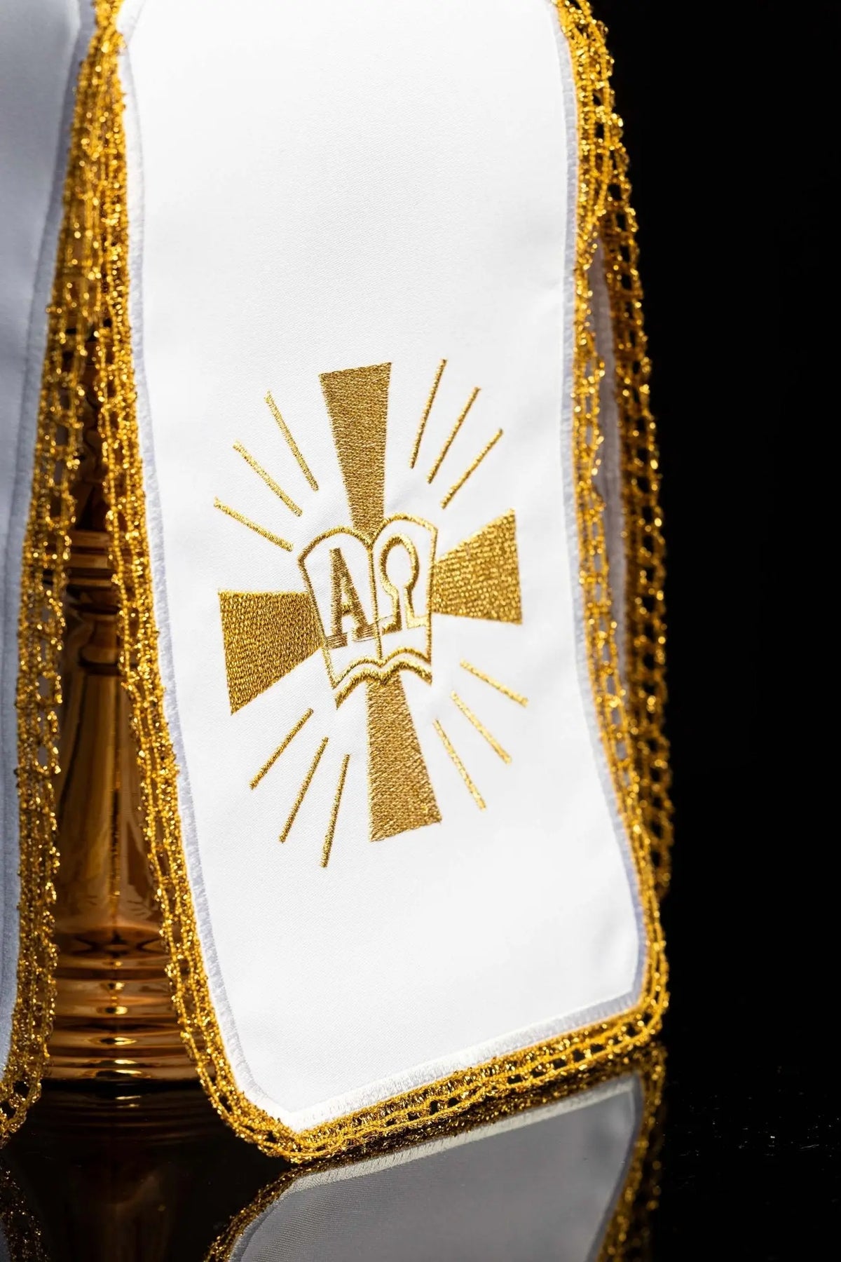 White ciborium veil with gold Alpha Omega embroidery, close-up view