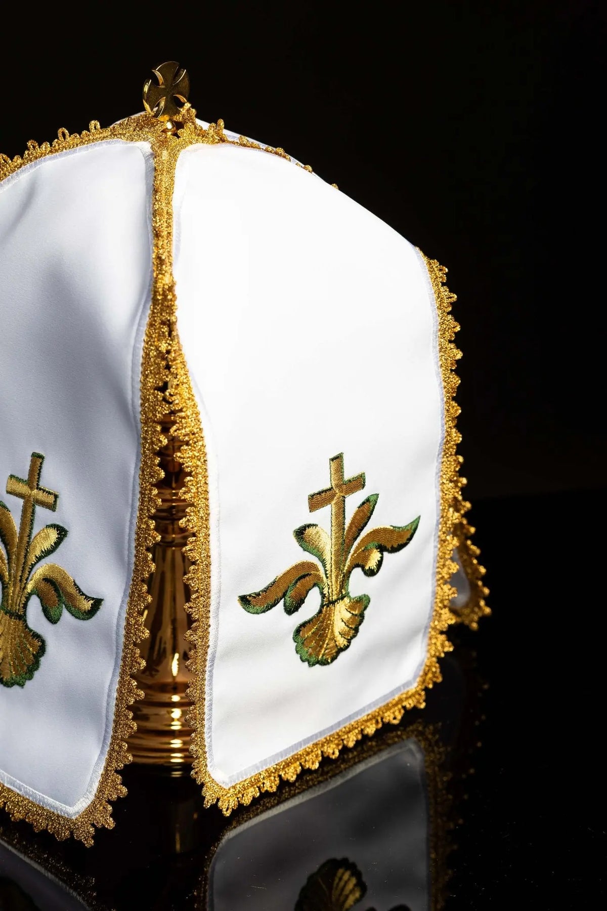 White ciborium veil with gold floral cross embroidery, angled view