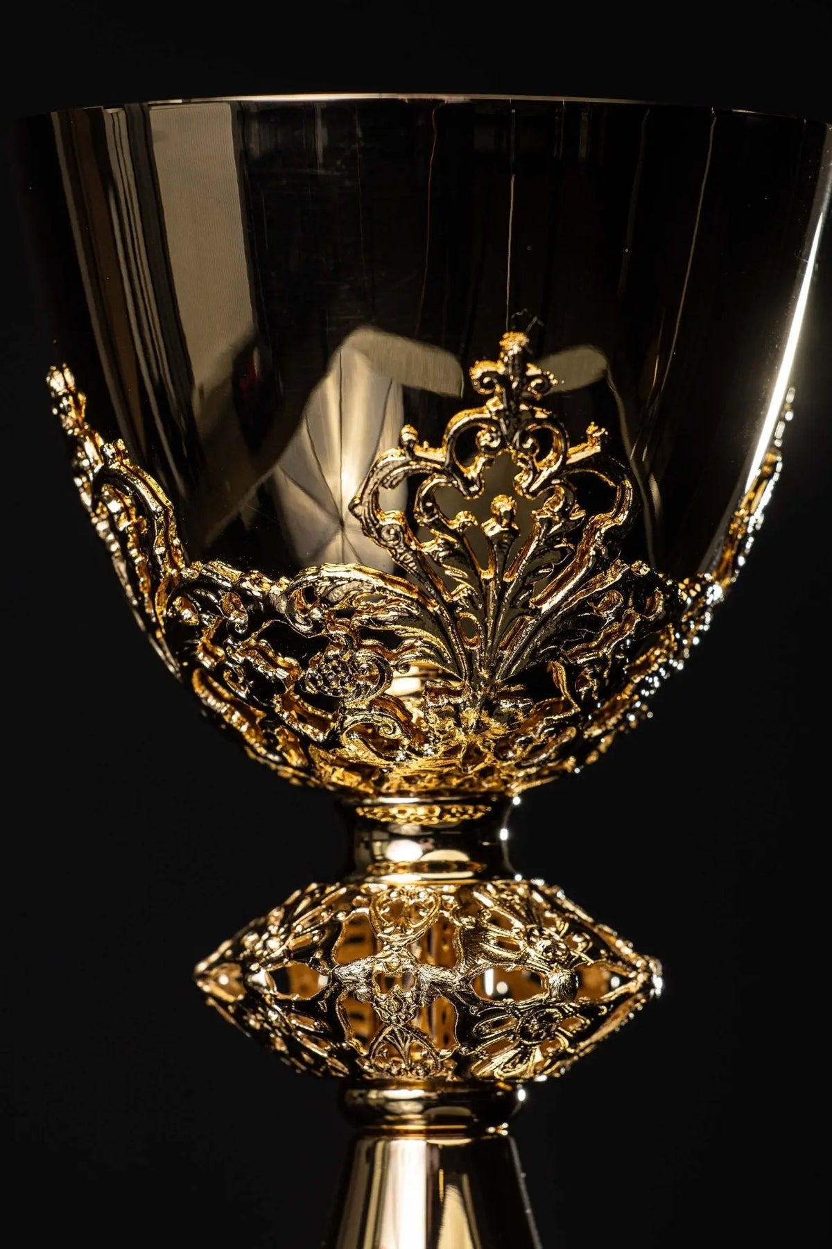 Gold-plated brass chalice with floral ornament, cup and stem close-up