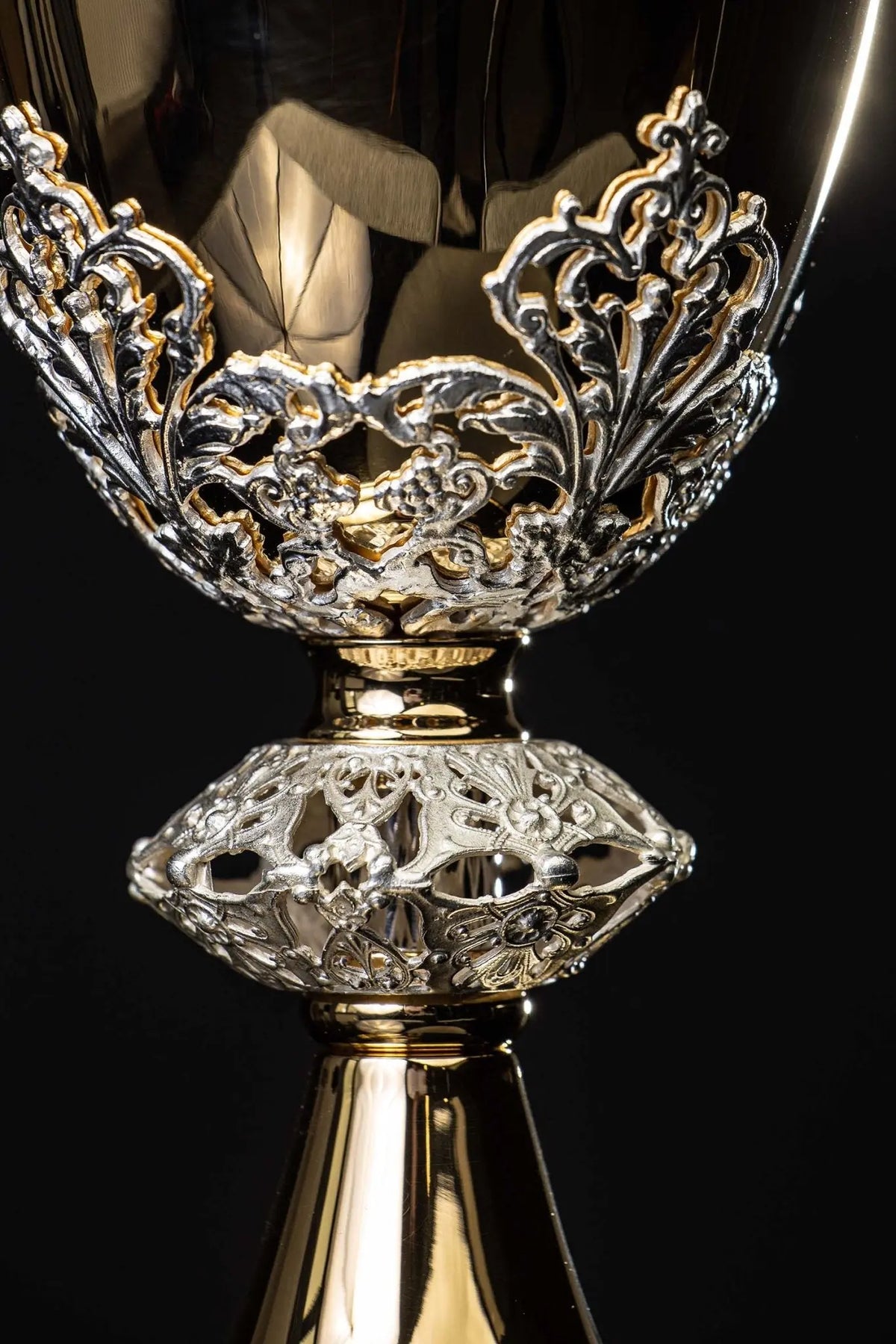 Gold-plated brass chalice with botanical ornament, close-up of cup and ornate stem