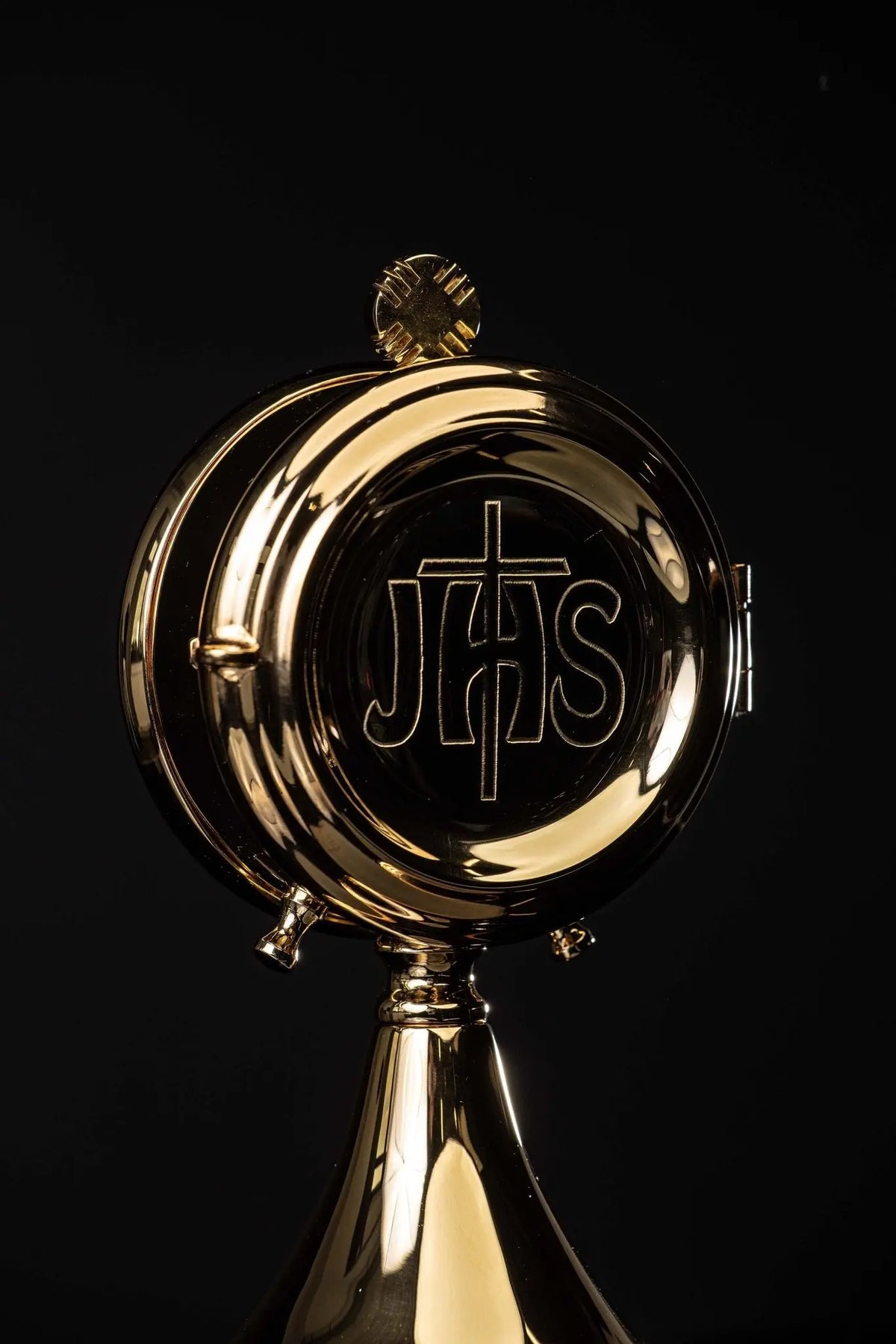 Brass luna holder with IHS motif, close front view
