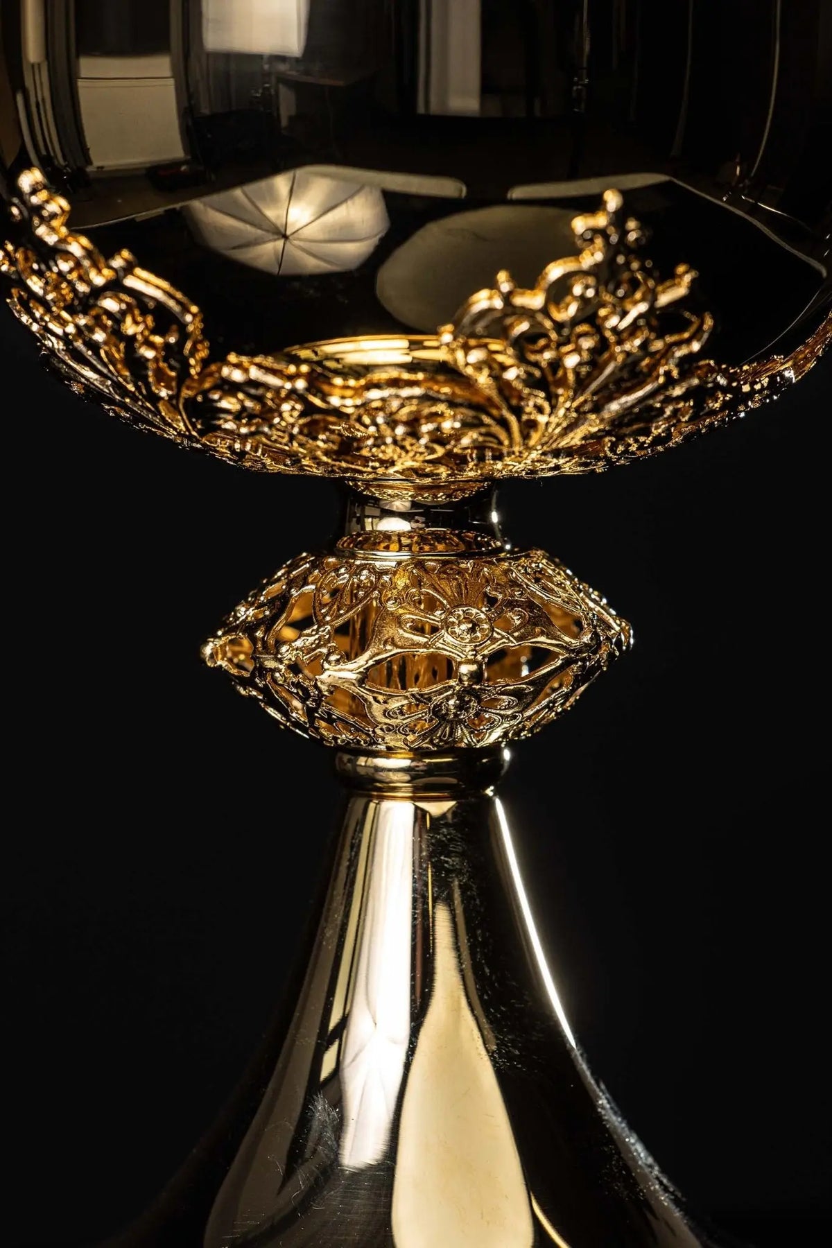 Gold ciborium with floral ornaments, close-up of the ornate stem