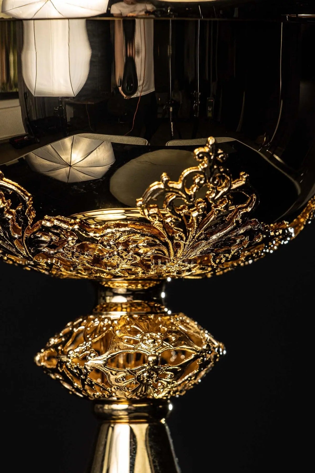 Gold ciborium with floral ornaments, close-up of the bowl and stem