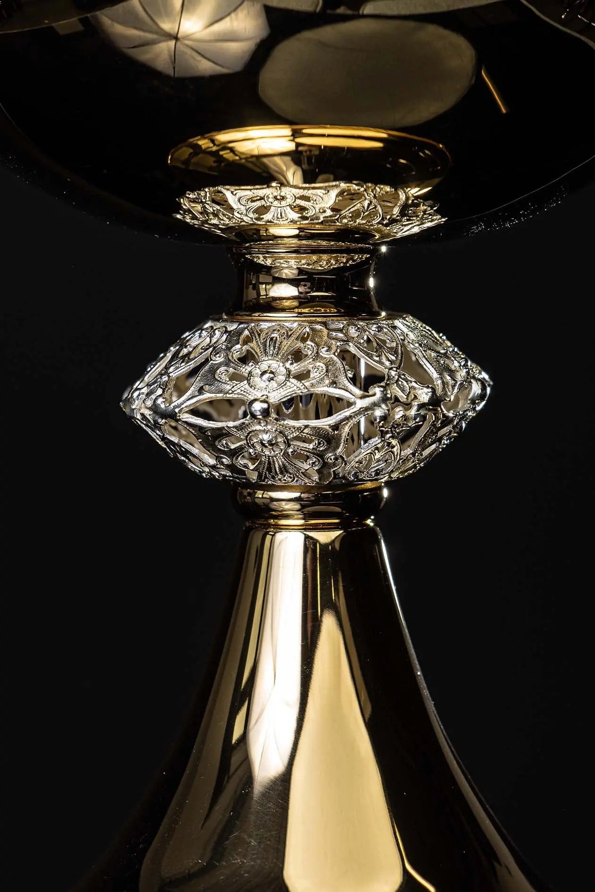 Gold-plated brass ciborium with cross, ornate stem close-up