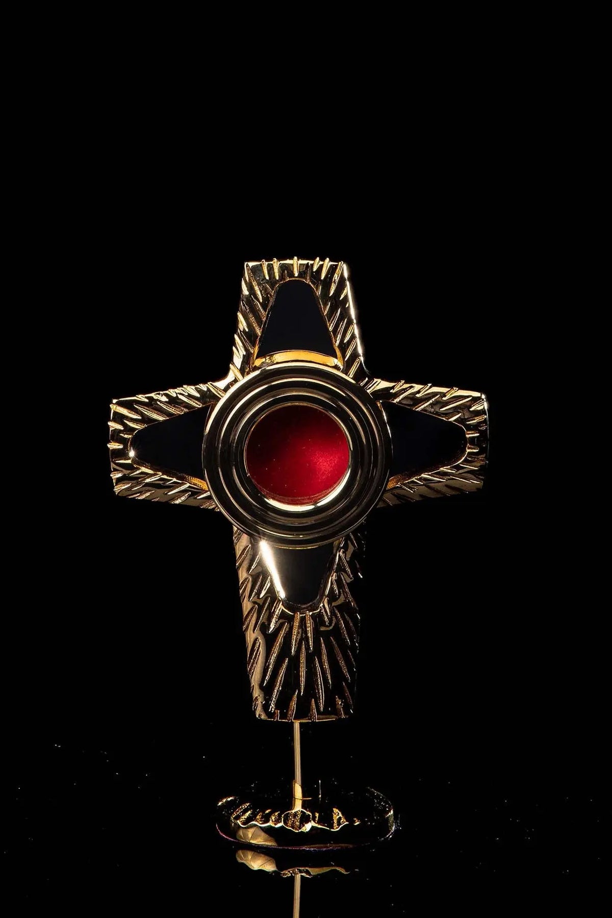 Gilded brass cross-shaped reliquary, handcrafted, front view with red central window