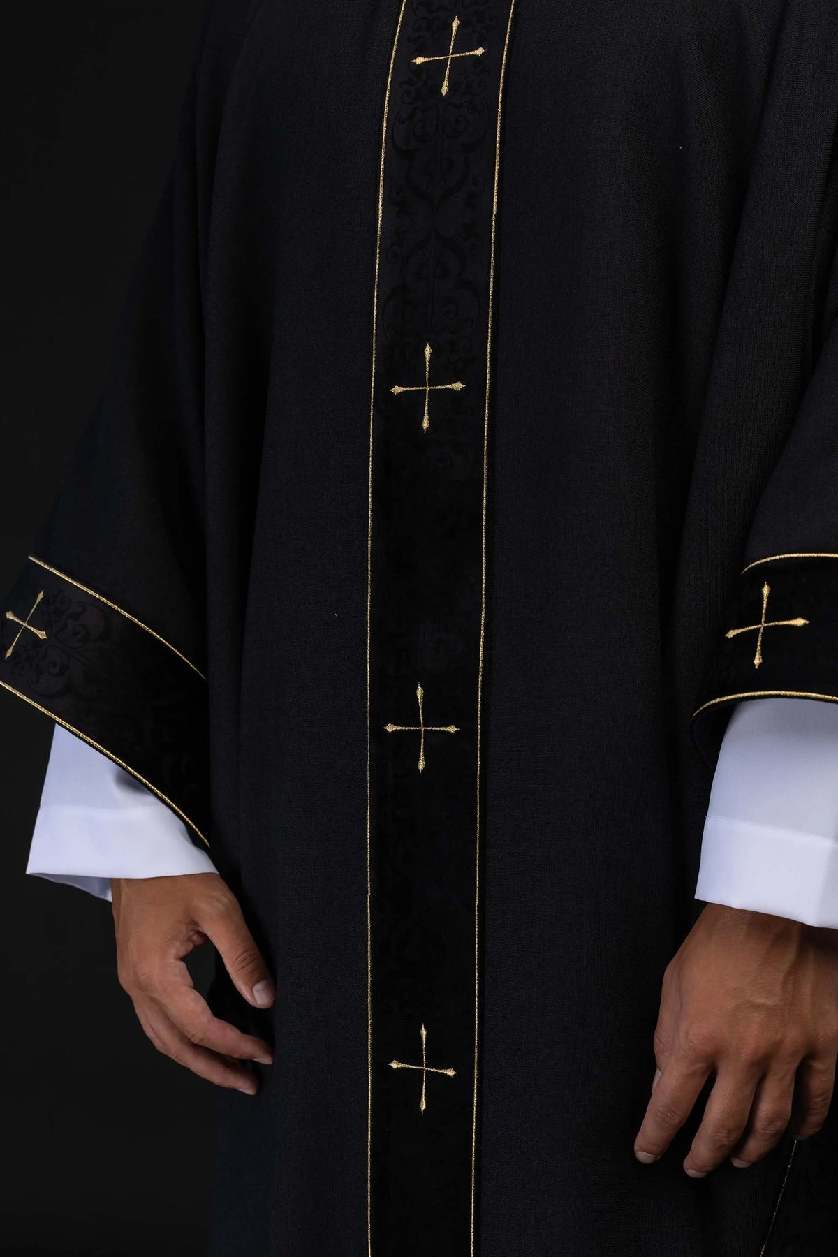 Black chasuble with gold crosses, front panel and cuffs close-up