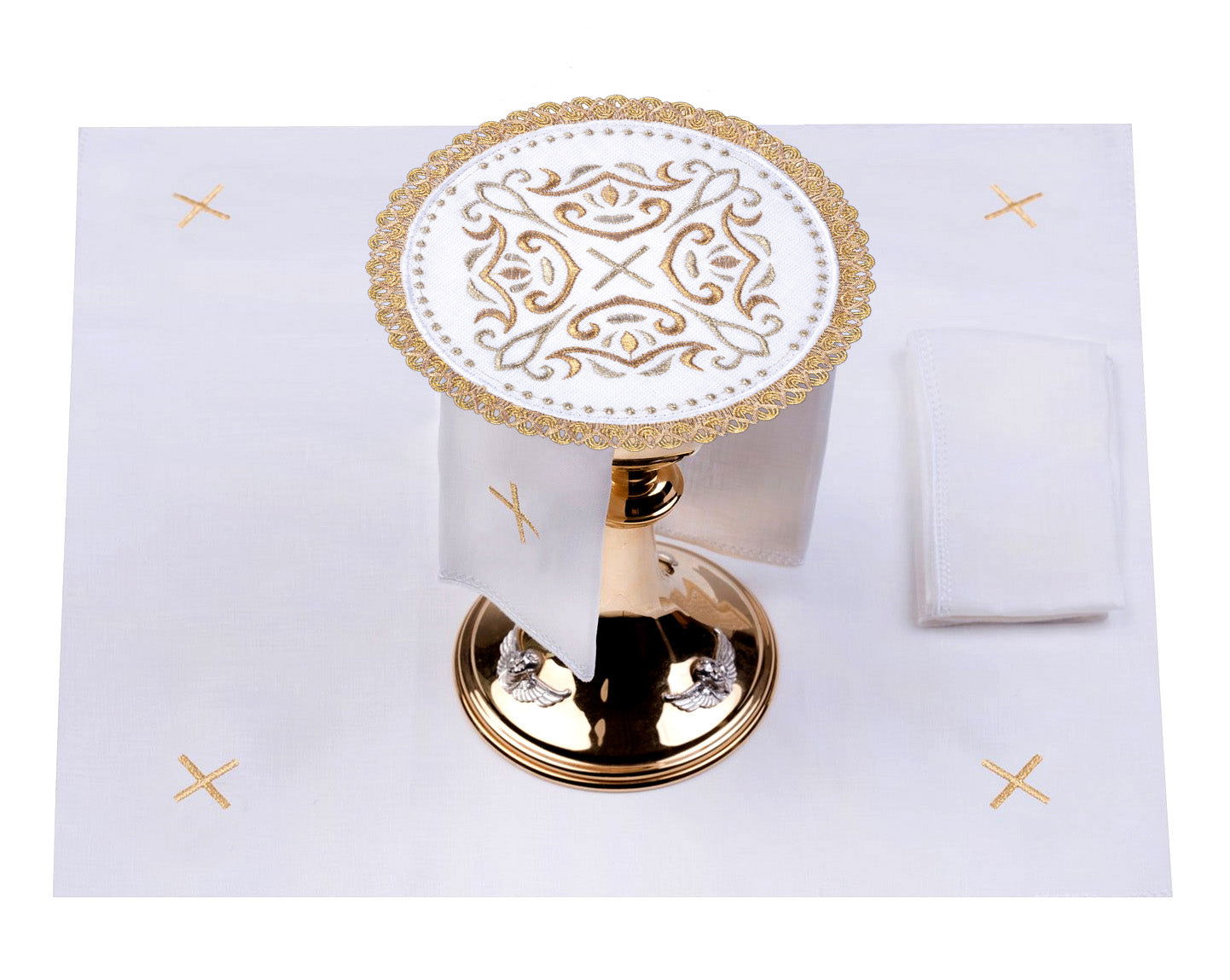 Linen cup set with a cross motif on a round palle surrounded by rich embroidery