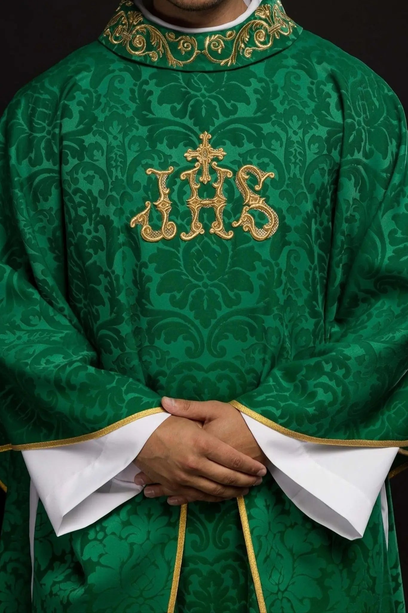 Green chasuble with IHS motif and richly embroidered collar on decorative fabric