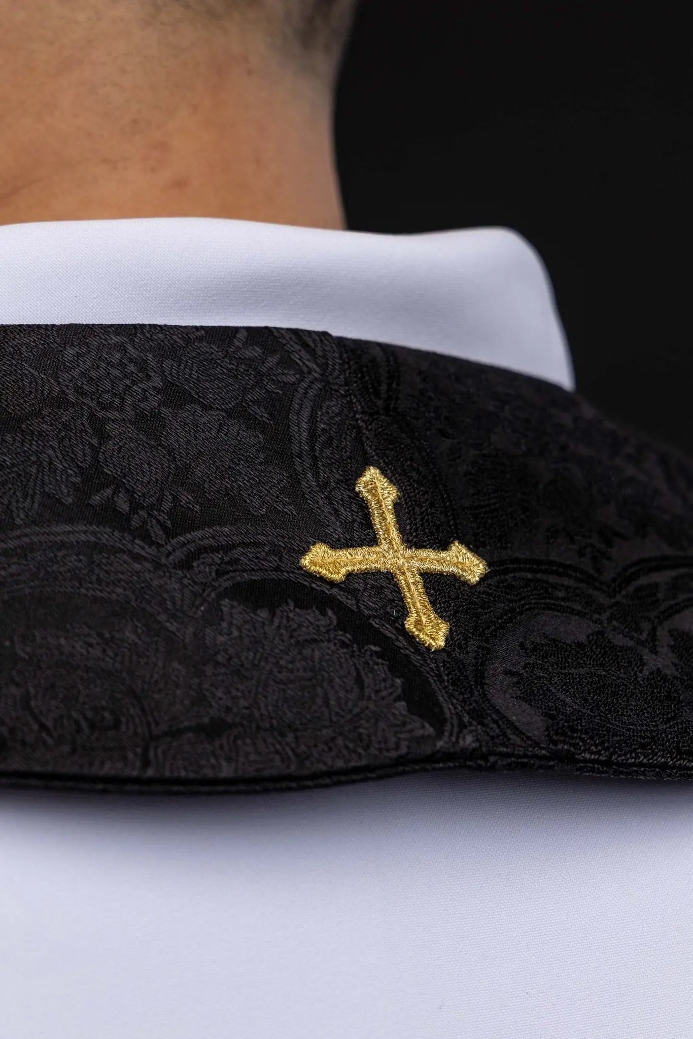 Black jacquard stole with embroidered gold crosses for liturgical use.