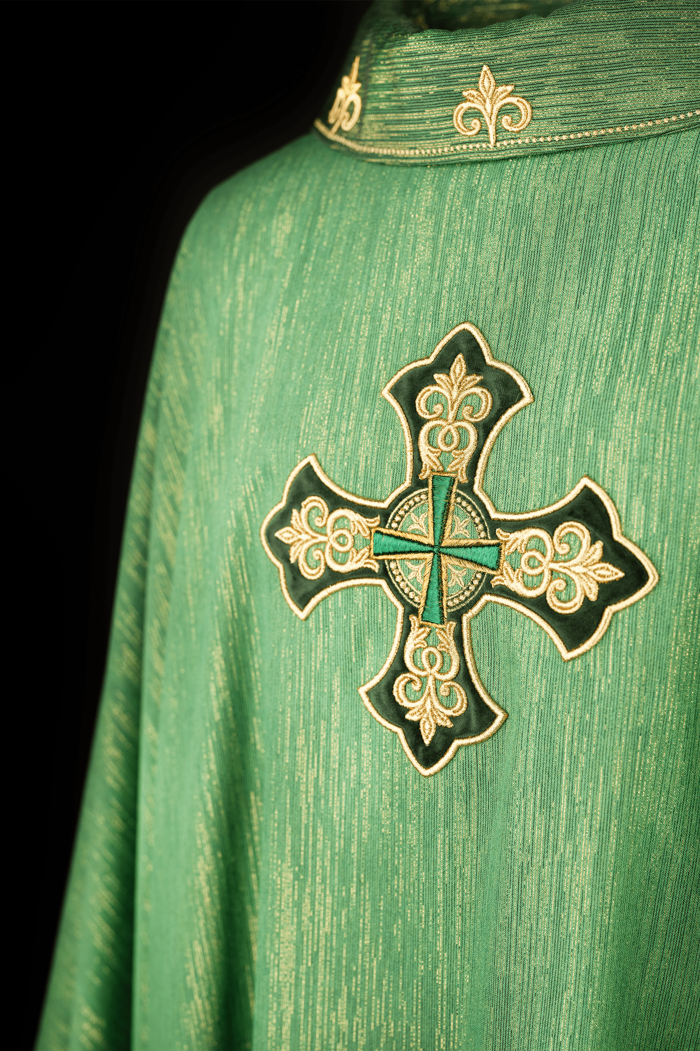 Green chasuble with richly embroidered cross and decorated collar